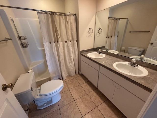 888 W Stuart St, Bartow, FL 33830 - bathroom featuring double vanity, tile patterned flooring, and shower / bathtub combination with curtain