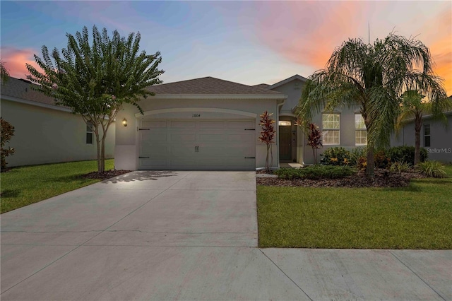 13804 Woodbridge Ter, Lakewood Ranch, FL 34211 - ranch-style home with stucco siding, a garage, driveway, and a front lawn