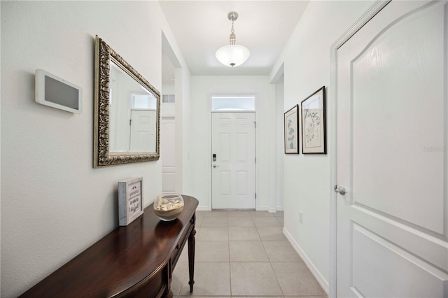 13804 Woodbridge Ter, Lakewood Ranch, FL 34211 - doorway with light tile patterned flooring and baseboards
