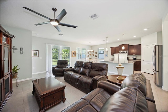 13804 Woodbridge Ter, Lakewood Ranch, FL 34211 - living room featuring a ceiling fan, light tile patterned floors, recessed lighting, and a chandelier