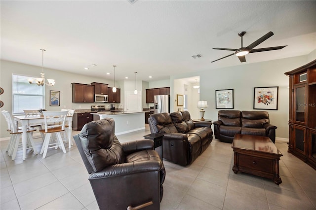13804 Woodbridge Ter, Lakewood Ranch, FL 34211 - living area with light tile patterned floors, a chandelier, and ceiling fan