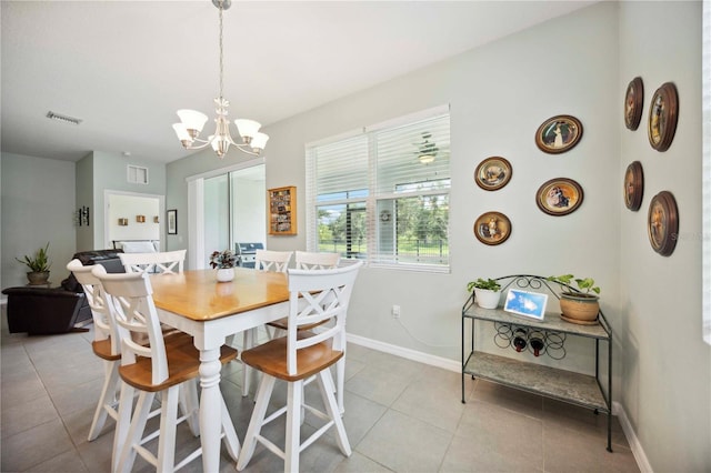 13804 Woodbridge Ter, Lakewood Ranch, FL 34211 - dining area with light tile patterned floors and a chandelier