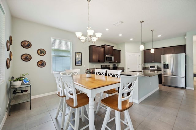 13804 Woodbridge Ter, Lakewood Ranch, FL 34211 - dining area featuring light tile patterned flooring, a chandelier, and recessed lighting