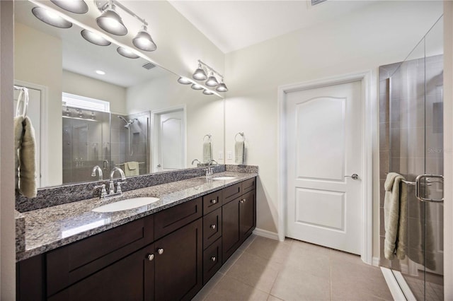 13804 Woodbridge Ter, Lakewood Ranch, FL 34211 - bathroom with double vanity, a stall shower, and tile patterned flooring