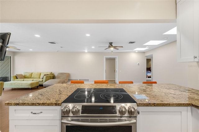 3658 Torrey Pines Way, Sarasota, FL 34238 - kitchen with electric stove, ceiling fan, white cabinetry, light stone countertops, and recessed lighting