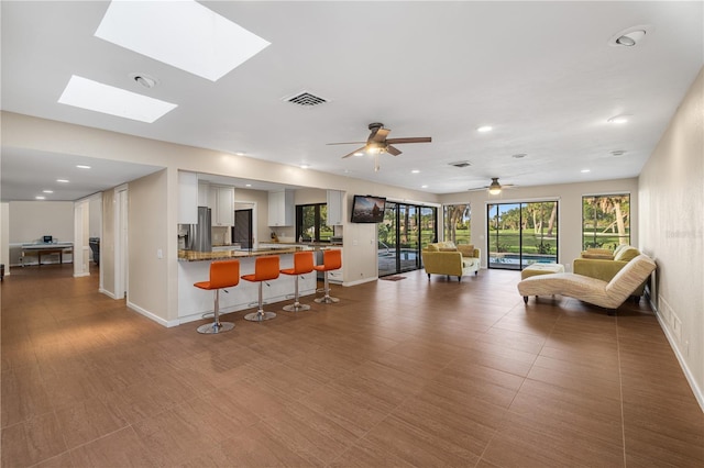 3658 Torrey Pines Way, Sarasota, FL 34238 - living area with recessed lighting, a skylight, and ceiling fan