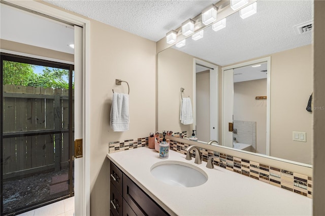 3658 Torrey Pines Way, Sarasota, FL 34238 - bathroom featuring vanity, a textured ceiling, backsplash, and tile patterned floors