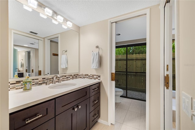 3658 Torrey Pines Way, Sarasota, FL 34238 - bathroom featuring vanity, decorative backsplash, tile patterned floors, and a textured ceiling