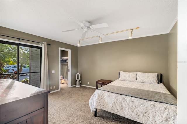 3658 Torrey Pines Way, Sarasota, FL 34238 - bedroom with rail lighting, light carpet, a spacious closet, and a ceiling fan