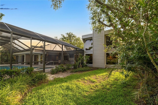 3658 Torrey Pines Way, Sarasota, FL 34238 - back of house with an outdoor pool, a lawn, and a lanai