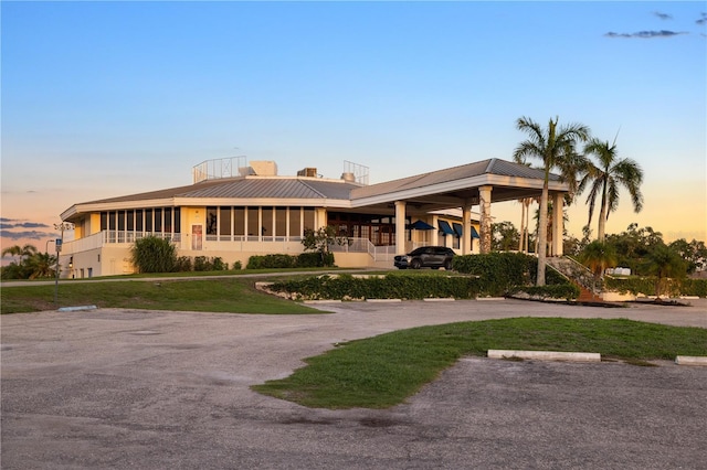3658 Torrey Pines Way, Sarasota, FL 34238 - view of front of property featuring a chimney, uncovered parking, and a metal roof