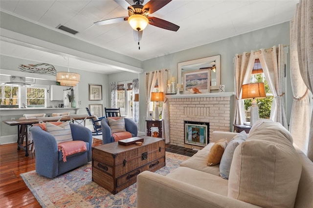 403 29th St NW, Bradenton, FL 34205 - living room with ceiling fan, healthy amount of natural light, hardwood / wood-style floors, and a fireplace