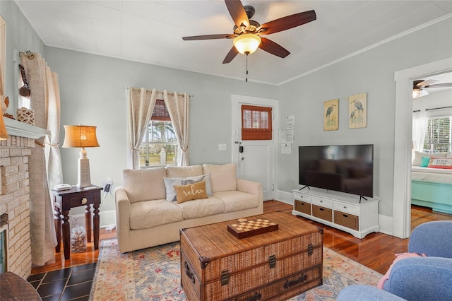 403 29th St NW, Bradenton, FL 34205 - living room with ceiling fan, a brick fireplace, wood finished floors, and ornamental molding