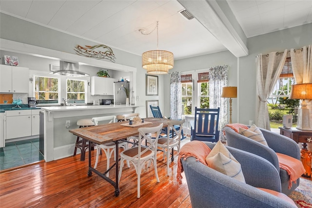 403 29th St NW, Bradenton, FL 34205 - dining room featuring healthy amount of natural light, dark wood-type flooring, a chandelier, and beamed ceiling