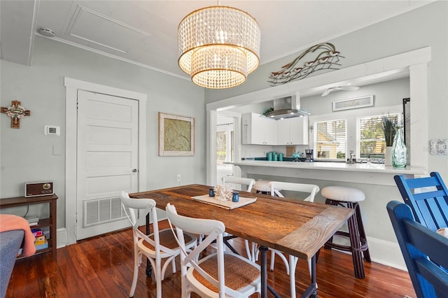 403 29th St NW, Bradenton, FL 34205 - dining space featuring hardwood / wood-style floors, crown molding, and a chandelier