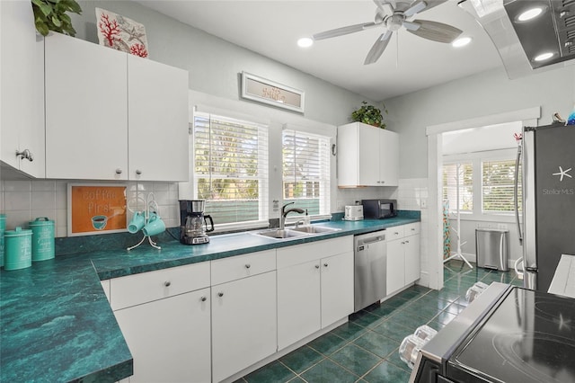 403 29th St NW, Bradenton, FL 34205 - kitchen with appliances with stainless steel finishes, dark tile patterned floors, white cabinets, tasteful backsplash, and recessed lighting