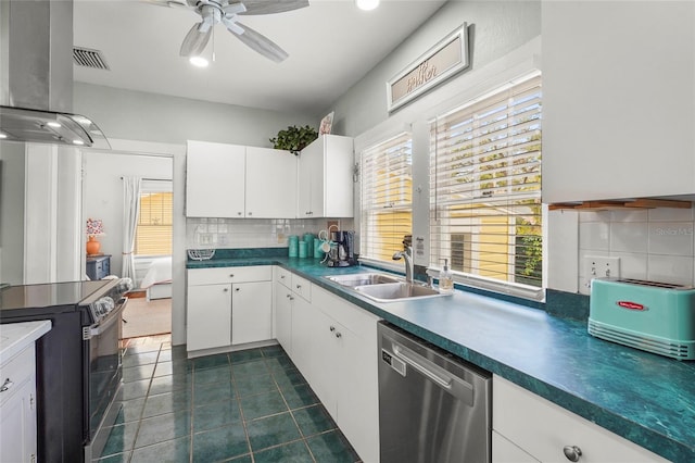 403 29th St NW, Bradenton, FL 34205 - kitchen featuring appliances with stainless steel finishes, island range hood, backsplash, a ceiling fan, and white cabinets