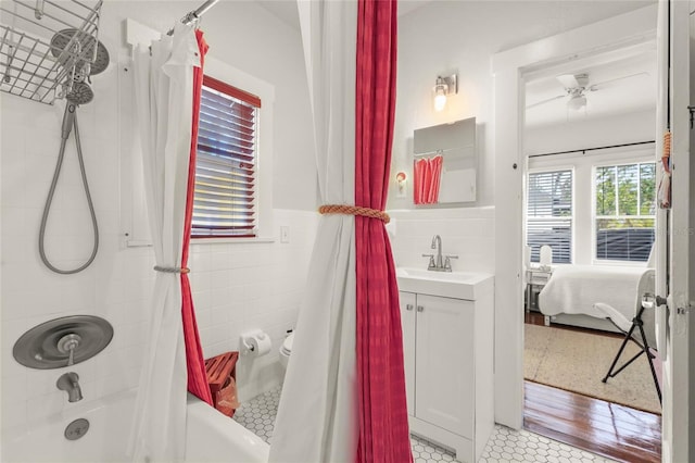 403 29th St NW, Bradenton, FL 34205 - full bath featuring vanity, shower / bath combo, ensuite bath, tile walls, and tile patterned floors