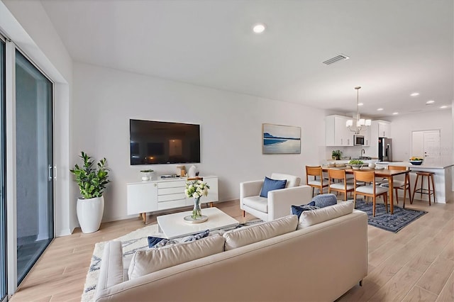 17823 Cherished Loop, Bradenton, FL 34211 - living area featuring a chandelier, light wood-style floors, and recessed lighting