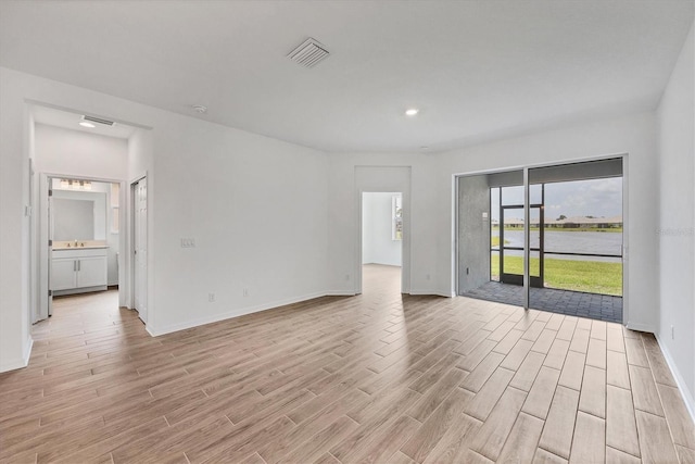 17823 Cherished Loop, Bradenton, FL 34211 - empty room with light wood-style flooring and recessed lighting