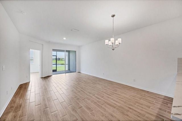17823 Cherished Loop, Bradenton, FL 34211 - unfurnished room featuring light wood-style flooring, a chandelier, and recessed lighting