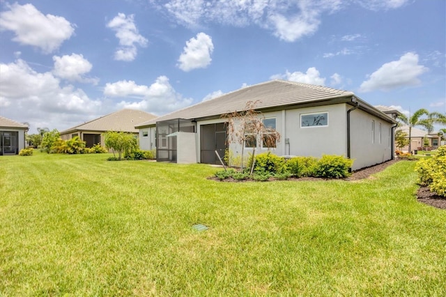 17823 Cherished Loop, Bradenton, FL 34211 - rear view of house with a lawn, a tiled roof, and stucco siding