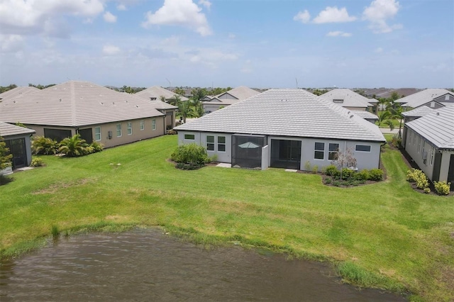 17823 Cherished Loop, Bradenton, FL 34211 - rear view of house with a residential view, a yard, a tiled roof, stucco siding, and a sunroom
