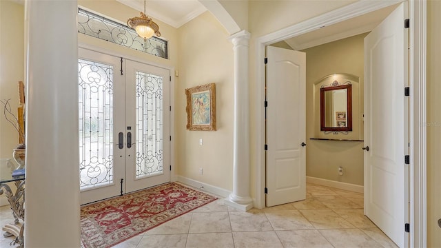 8832 Enclave Ct, Sarasota, FL 34238 - entrance foyer with arched walkways, french doors, ornamental molding, ornate columns, and light tile patterned floors