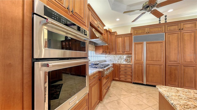 8832 Enclave Ct, Sarasota, FL 34238 - kitchen featuring appliances with stainless steel finishes, ornamental molding, brown cabinets, a ceiling fan, and backsplash
