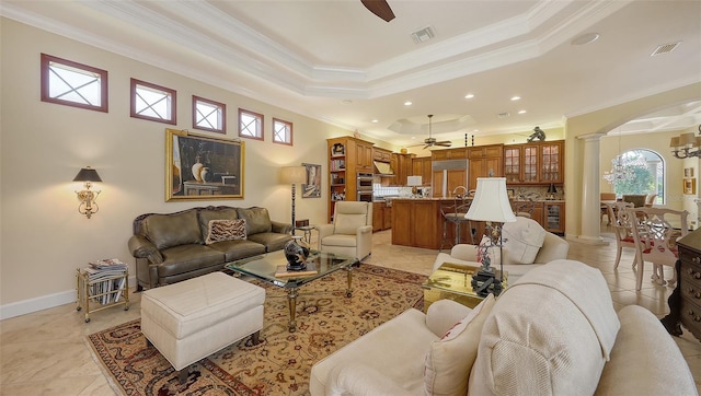 8832 Enclave Ct, Sarasota, FL 34238 - living area with a ceiling fan, decorative columns, ornamental molding, arched walkways, and plenty of natural light