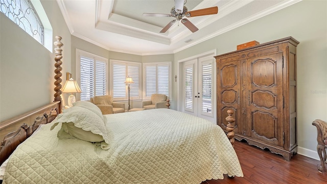 8832 Enclave Ct, Sarasota, FL 34238 - bedroom featuring dark wood-type flooring, access to exterior, french doors, a tray ceiling, and a ceiling fan