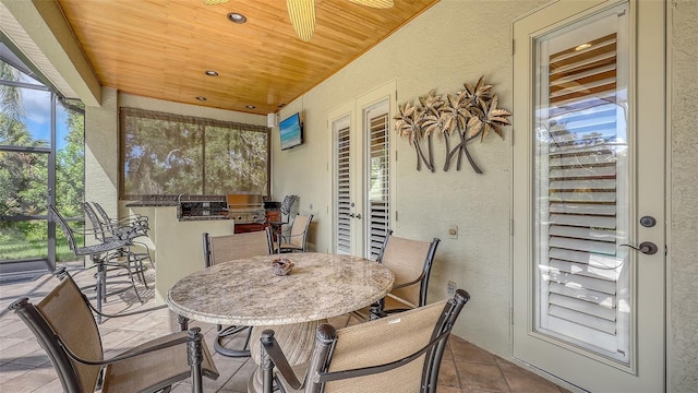 8832 Enclave Ct, Sarasota, FL 34238 - sunroom / solarium featuring a textured wall, an outdoor kitchen, tile patterned floors, wood ceiling, and outdoor dining space