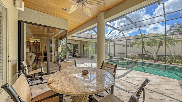 8832 Enclave Ct, Sarasota, FL 34238 - view of patio featuring ceiling fan, a pool with connected hot tub, outdoor dining space, and glass enclosure