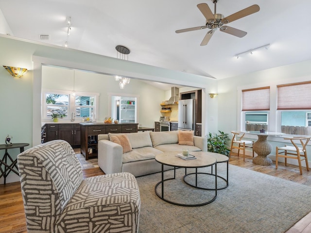 1732 6th St, Sarasota, FL 34236 - living area featuring rail lighting, wood finished floors, lofted ceiling, and a ceiling fan