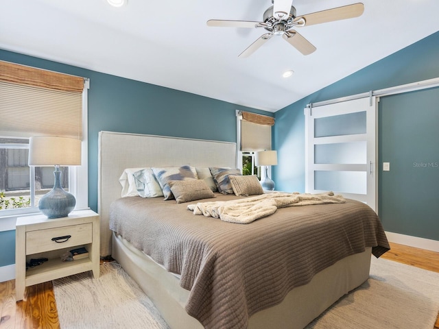 1732 6th St, Sarasota, FL 34236 - bedroom with wood finished floors, lofted ceiling, a ceiling fan, and a barn door