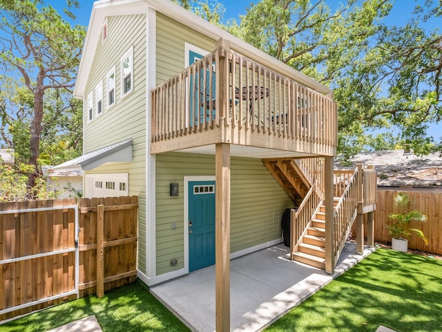 1732 6th St, Sarasota, FL 34236 - back of property with a wooden deck, stairs, and a patio area