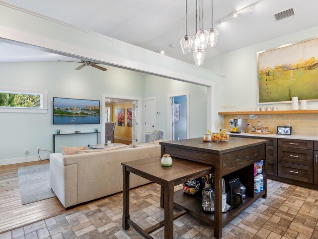 1732 6th St, Sarasota, FL 34236 - living room with rail lighting, vaulted ceiling, and ceiling fan