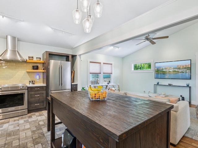 1732 6th St, Sarasota, FL 34236 - kitchen featuring wall chimney exhaust hood, appliances with stainless steel finishes, backsplash, open floor plan, and lofted ceiling