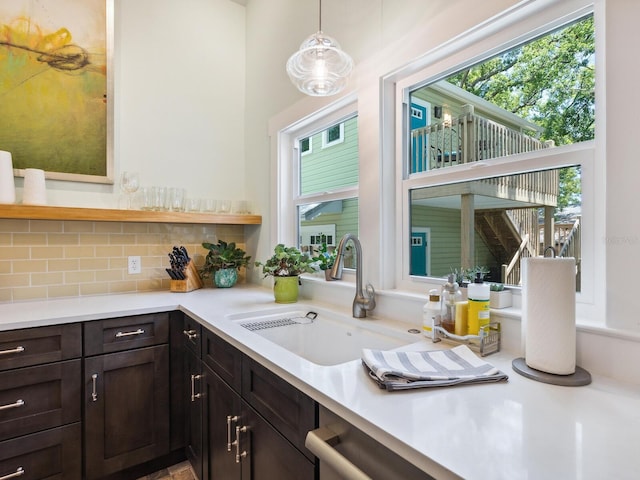 1732 6th St, Sarasota, FL 34236 - kitchen with healthy amount of natural light, light countertops, dark brown cabinets, and decorative backsplash
