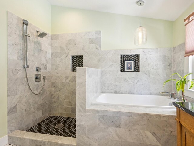 1732 6th St, Sarasota, FL 34236 - bathroom featuring a garden tub, vanity, and a walk in shower