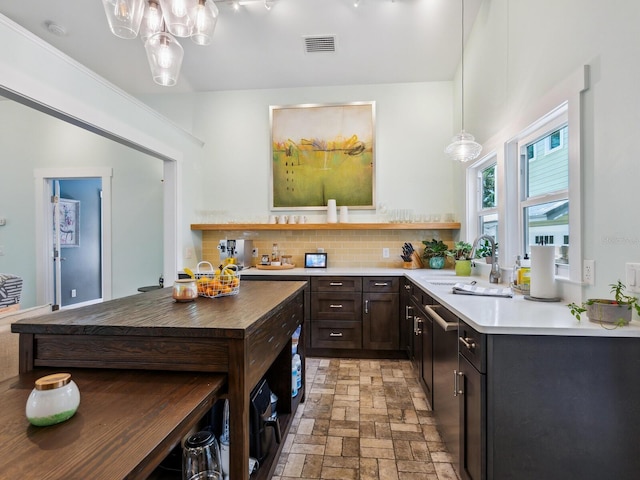 1732 6th St, Sarasota, FL 34236 - kitchen with open shelves, tasteful backsplash, light countertops, pendant lighting, and dark brown cabinetry
