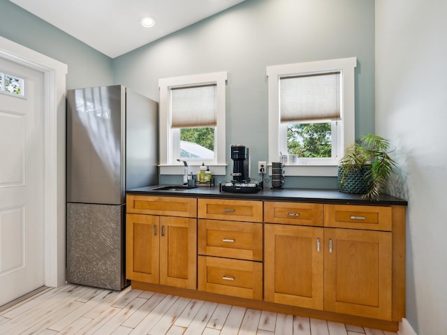 1732 6th St, Sarasota, FL 34236 - kitchen with freestanding refrigerator, healthy amount of natural light, brown cabinets, and dark countertops