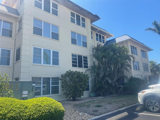 3806 Gulf Of Mexico Dr Unit C205, Longboat Key, FL 34228 - view of building exterior with uncovered parking