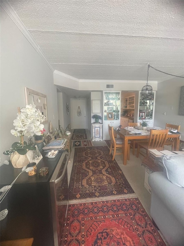 3806 Gulf Of Mexico Dr Unit C205, Longboat Key, FL 34228 - carpeted dining room featuring a textured ceiling, a chandelier, and crown molding