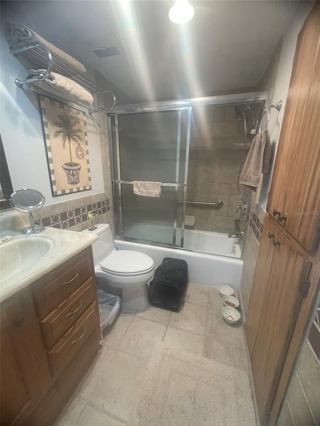 3806 Gulf Of Mexico Dr Unit C205, Longboat Key, FL 34228 - bathroom with vanity, bath / shower combo with glass door, tile walls, and tile patterned floors