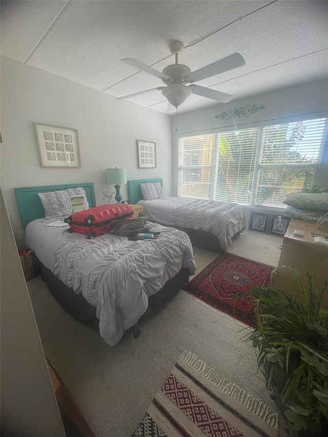 3806 Gulf Of Mexico Dr Unit C205, Longboat Key, FL 34228 - carpeted bedroom with multiple windows, a textured ceiling, and ceiling fan