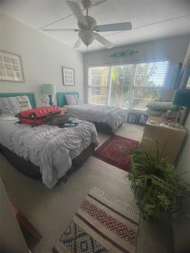 3806 Gulf Of Mexico Dr Unit C205, Longboat Key, FL 34228 - carpeted bedroom featuring a ceiling fan and a textured ceiling