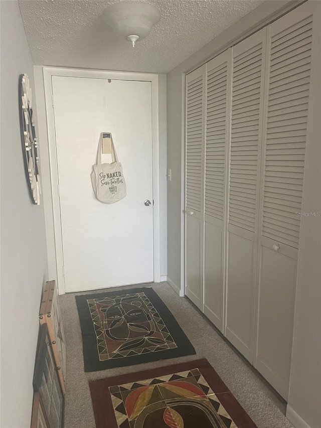 3806 Gulf Of Mexico Dr Unit C205, Longboat Key, FL 34228 - hall with carpet flooring and a textured ceiling
