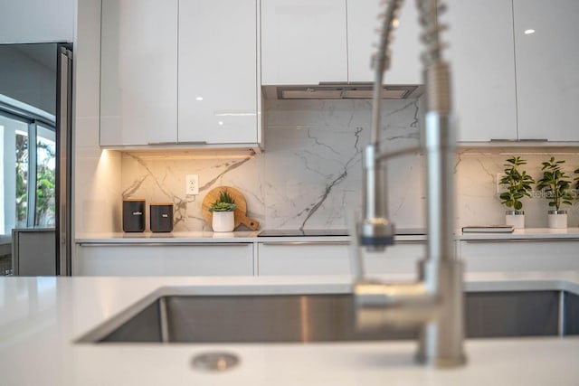 2124 Clematis Pl, Sarasota, FL 34239 - kitchen view of white cabinetry, backsplash, and modern cabinets