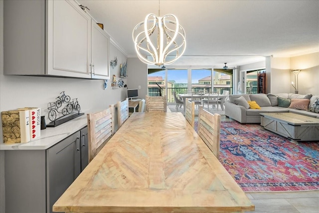 8750 Midnight Pass Rd Unit 501, Sarasota, FL 34242 - dining area with a chandelier, floor to ceiling windows, ornamental molding, and wood finished floors
